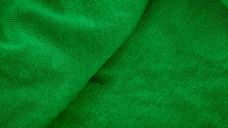 green cotton fabric with visible details. background