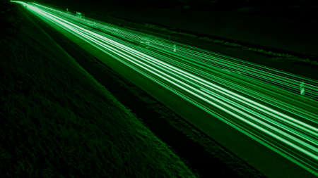 green car lights at night. long exposureの写真素材