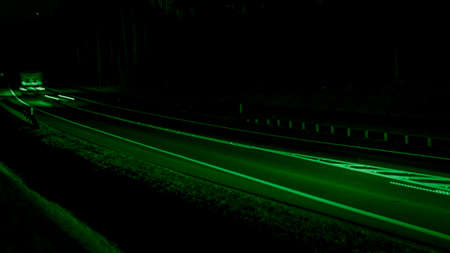 green car lights at night. long exposure