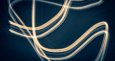 golden light lines on blue backgroundの写真素材