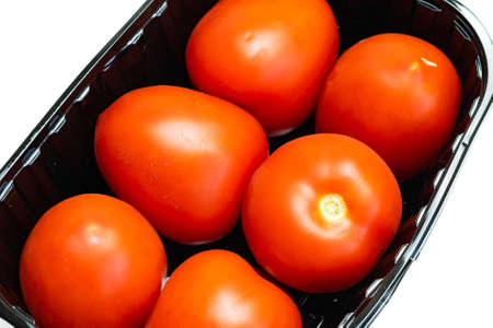 red tomatoes on a white isolated backgroundの写真素材