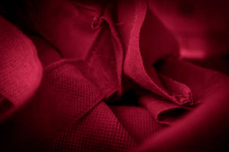 red cotton fabric with visible details. background or texturaの写真素材