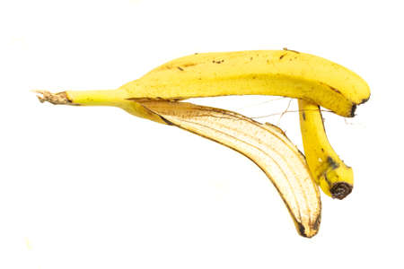 yellow banana peel on a white isolated backgroundの写真素材