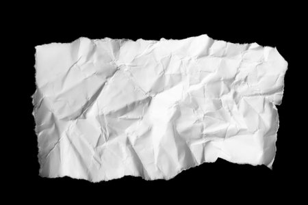 a white piece of paper on a black isolated backgroundの写真素材