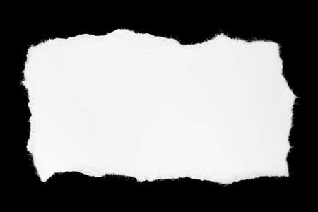 a white piece of paper on a black isolated backgroundの写真素材