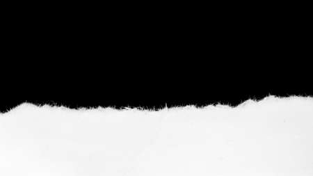 a white piece of paper on a black isolated backgroundの写真素材