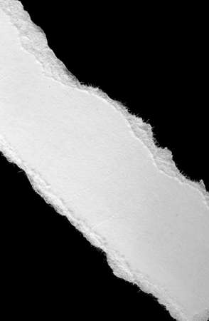 a white piece of paper on a black isolated backgroundの写真素材