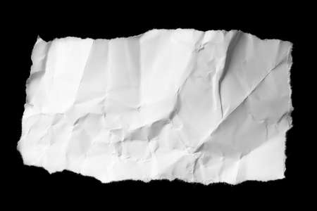 a white piece of paper on a black isolated backgroundの写真素材