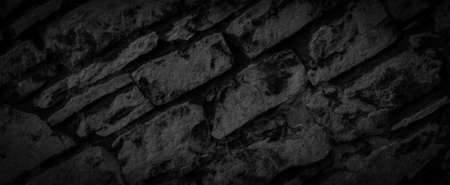 black limestone rock with visible details. background or textureの写真素材