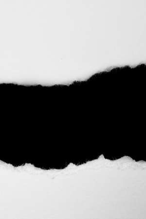 a white piece of paper on a black isolated backgroundの写真素材