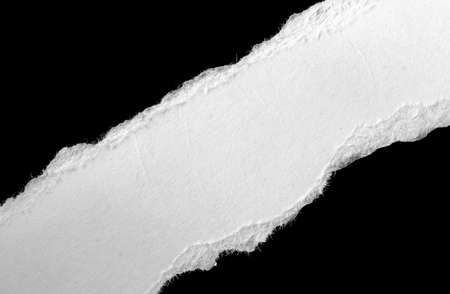 a white piece of paper on a black isolated backgroundの写真素材