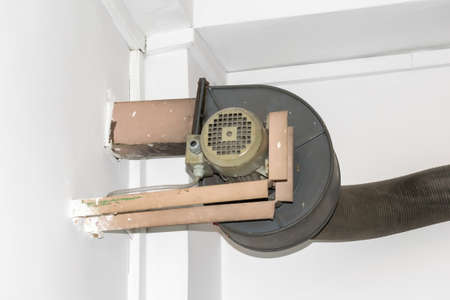 old air blower on the background of a white wallの写真素材