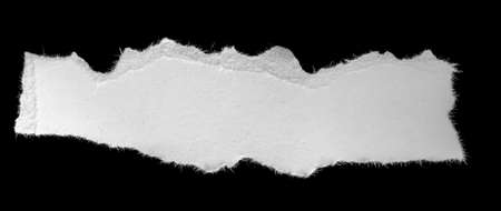 a white piece of paper on a black isolated backgroundの写真素材