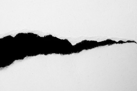 a white piece of paper on a black isolated backgroundの写真素材