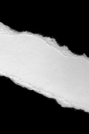 a white piece of paper on a black isolated backgroundの写真素材