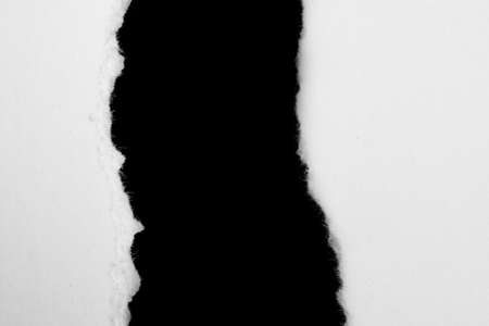 a white piece of paper on a black isolated backgroundの写真素材
