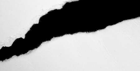 a white piece of paper on a black isolated backgroundの写真素材