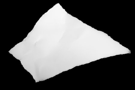 a white piece of paper on a black isolated backgroundの写真素材