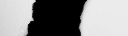 a white piece of paper on a black isolated backgroundの写真素材