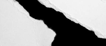 a white piece of paper on a black isolated backgroundの写真素材