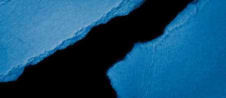 blue piece of paper on black isolated backgroundの写真素材