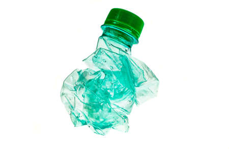 crumpled green plastic bottle on white isolated background