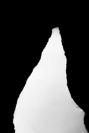 a white piece of paper on a black isolated backgroundの写真素材