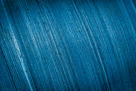 old wall painted with blue paint with visible textureの写真素材