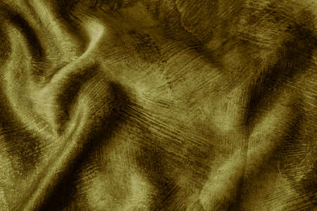Crinkled golden cotton fabric with visible textureの写真素材