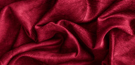 Crinkled red cotton fabric with visible textureの写真素材