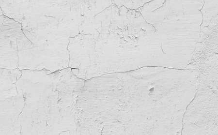 white cracked wall with visible details. backgroundの写真素材