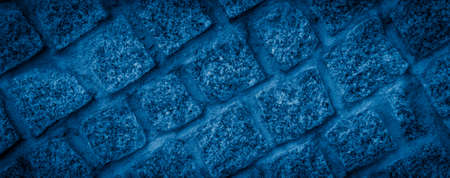 a blue stone wall with visible textureの写真素材