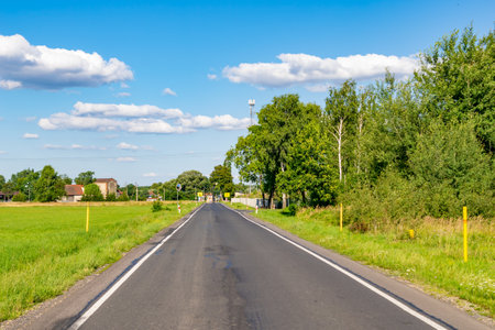 road on a beautiful sunny day against the backdrop of a blue skyの写真素材