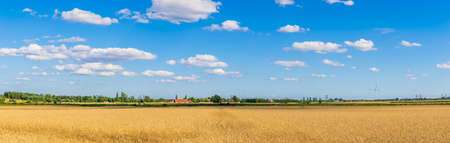 farmland on a beautiful sunny day against the background of blue skyの写真素材