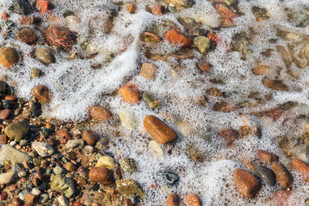 sea waves and stones on the beachの写真素材