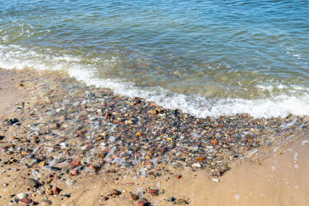 sea waves and stones on the beachの写真素材