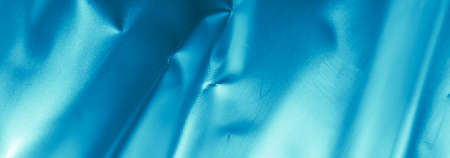 crinkled blue foil with visible details. background or textureの写真素材