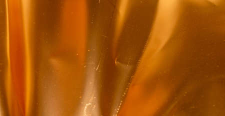 crinkled gold foil with visible details. background or textureの写真素材