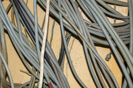 gray wires on a background of a yellow wallの写真素材