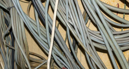 gray wires on a background of a yellow wallの写真素材