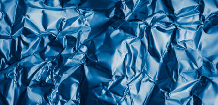 crinkled blue foil with visible details. background or textureの写真素材
