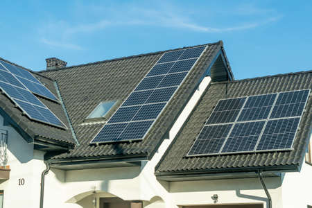 solar panels on the black roof of a single family houseの写真素材