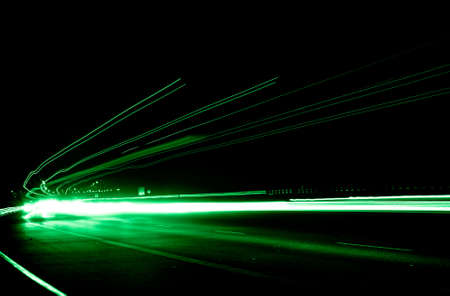 green car lights at night. long exposure