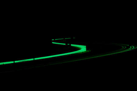 green car lights at night. long exposure