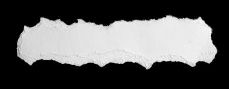 a white piece of paper on a black isolated backgroundの写真素材