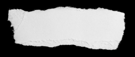 a white piece of paper on a black isolated backgroundの写真素材
