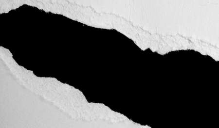 a white piece of paper on a black isolated backgroundの写真素材