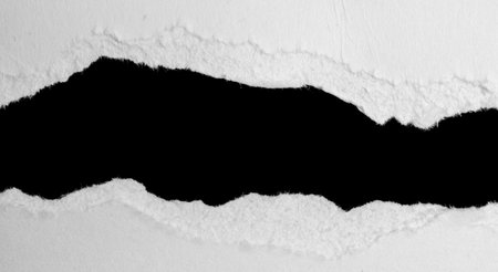 a white piece of paper on a black isolated backgroundの写真素材