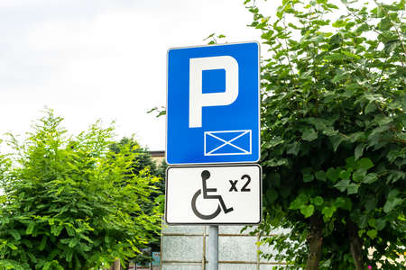 road sign with disabled parking space designationの写真素材