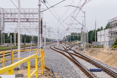railroad tracks at a train station on a cloudy dayの写真素材